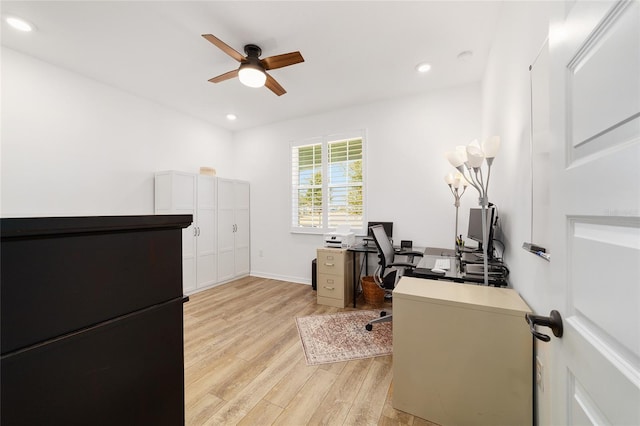 home office with ceiling fan and light hardwood / wood-style floors