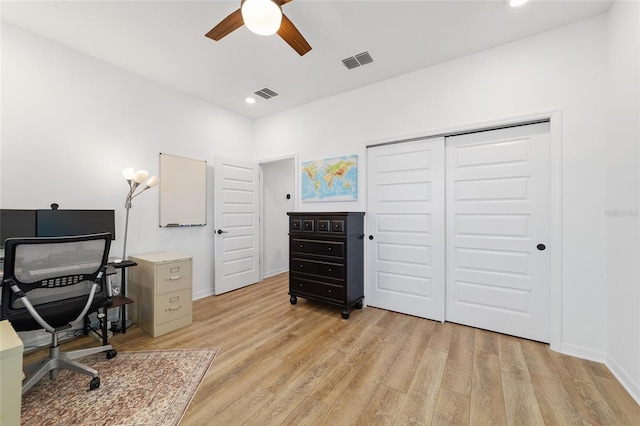 home office featuring ceiling fan and light hardwood / wood-style flooring