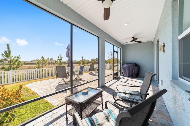 sunroom featuring ceiling fan