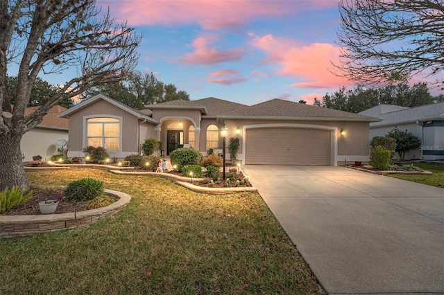 view of front facade featuring a garage and a lawn