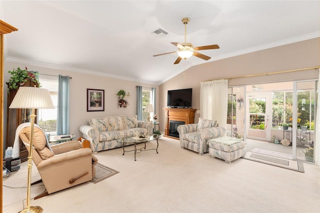 carpeted living room featuring crown molding, plenty of natural light, ceiling fan, and vaulted ceiling