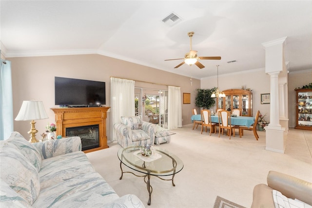 living room with lofted ceiling, light colored carpet, ornamental molding, ceiling fan, and decorative columns