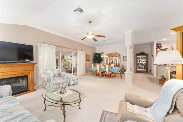 carpeted living room featuring ornate columns, ornamental molding, lofted ceiling, and ceiling fan