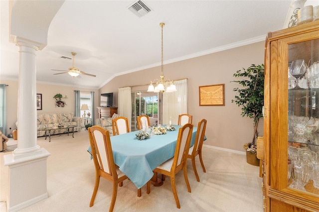 dining space featuring decorative columns, vaulted ceiling, light carpet, ornamental molding, and ceiling fan with notable chandelier