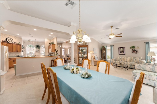 dining room featuring lofted ceiling, light colored carpet, ceiling fan with notable chandelier, and ornamental molding