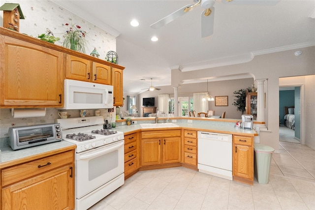 kitchen featuring sink, white appliances, ceiling fan, and ornate columns