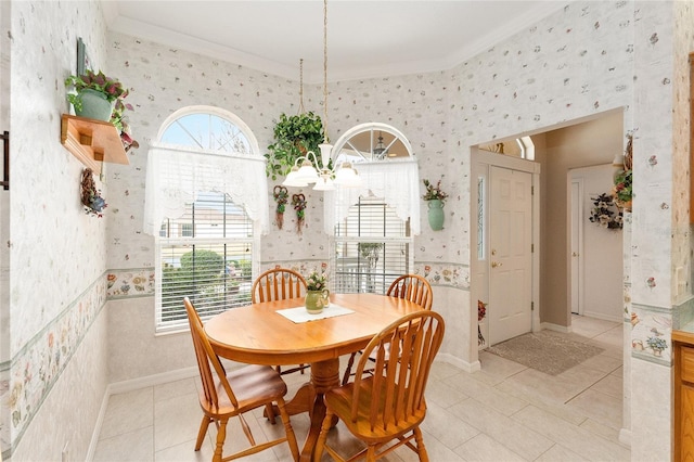 dining space with ornamental molding, plenty of natural light, and a notable chandelier