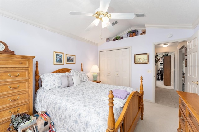 carpeted bedroom with crown molding, ceiling fan, vaulted ceiling, and a closet