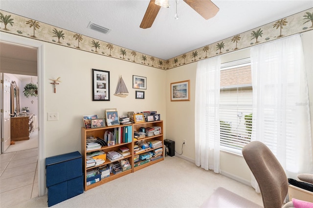 carpeted office with ceiling fan and a textured ceiling