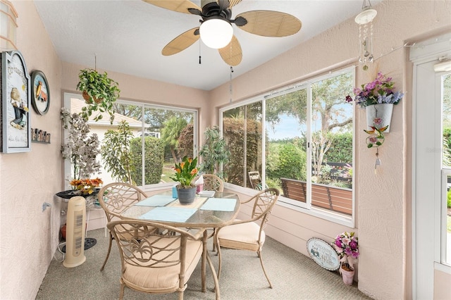 sunroom with ceiling fan and a healthy amount of sunlight