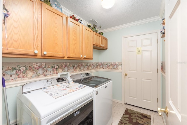 laundry area featuring light tile patterned flooring, crown molding, cabinets, separate washer and dryer, and a textured ceiling