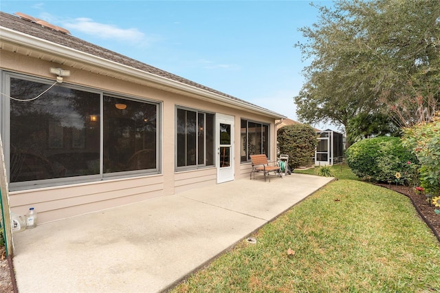 rear view of property featuring a lawn and a patio