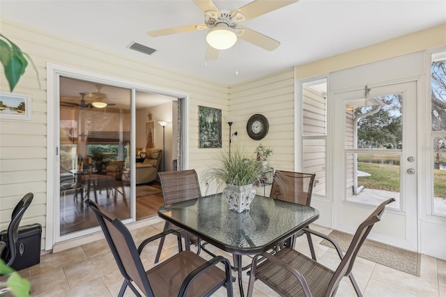 tiled dining area featuring ceiling fan