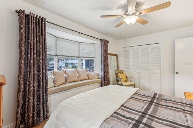 bedroom featuring ceiling fan and a closet