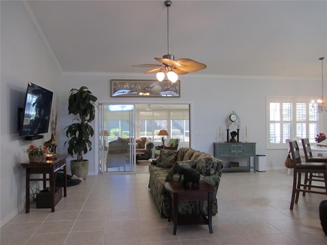 tiled living room featuring crown molding, plenty of natural light, and ceiling fan with notable chandelier