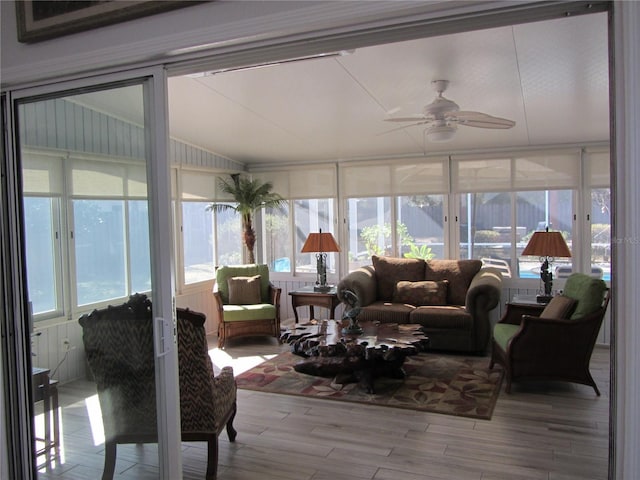 sunroom with lofted ceiling and ceiling fan