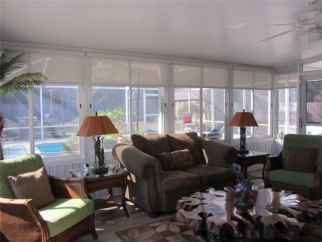 sunroom / solarium featuring ceiling fan