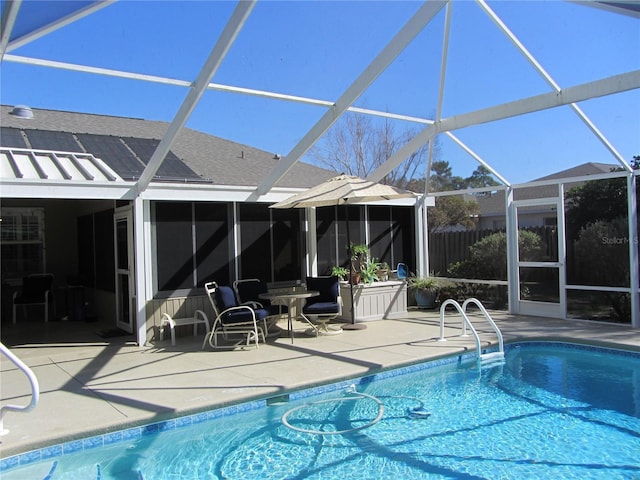 view of swimming pool with a patio area and glass enclosure