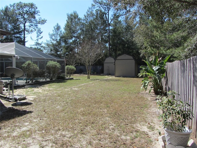 view of yard with a lanai and a storage unit