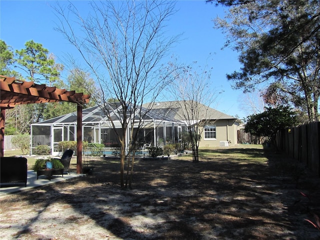 view of yard with a lanai, a pergola, and a patio area