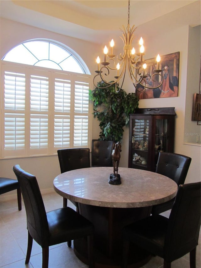 dining space featuring light tile patterned flooring and a notable chandelier