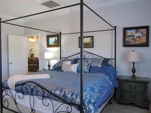 bedroom with tile patterned flooring and ornamental molding