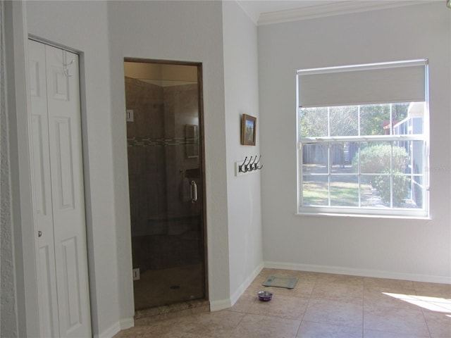 bathroom featuring tile patterned flooring, ornamental molding, and walk in shower