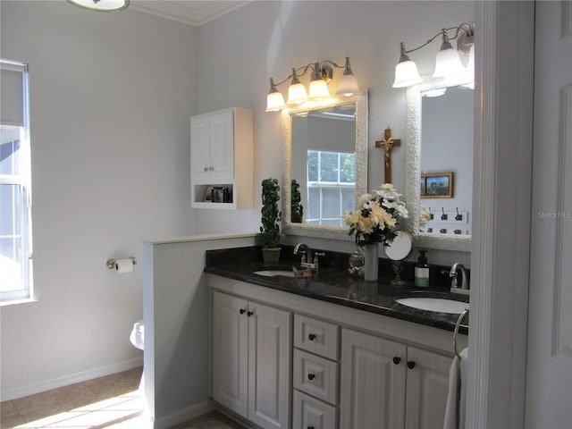 bathroom with tile patterned floors, vanity, and ornamental molding