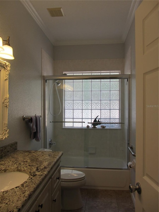 full bathroom with tile patterned flooring, enclosed tub / shower combo, vanity, ornamental molding, and toilet