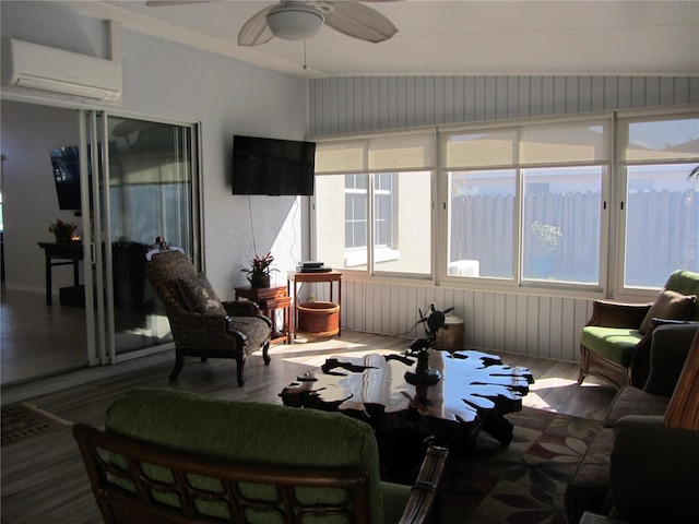 sunroom with ceiling fan and a wall mounted AC