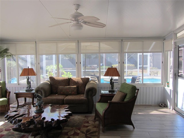 sunroom / solarium featuring ceiling fan