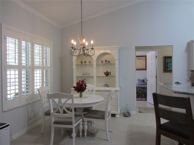 dining space with light tile patterned flooring, a chandelier, vaulted ceiling, and ornamental molding