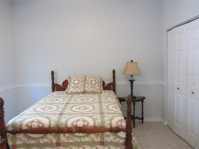 bedroom featuring a closet and light tile patterned flooring