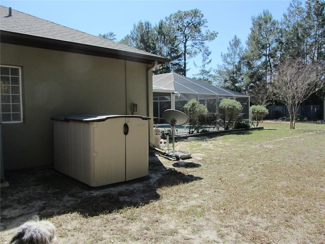 view of yard with a swimming pool and glass enclosure