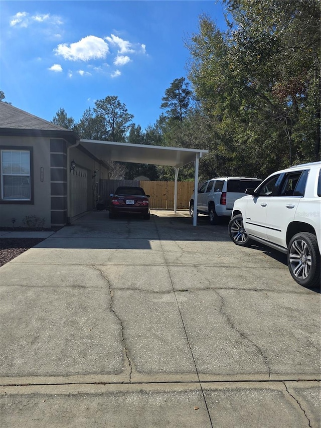 view of vehicle parking featuring a garage and a carport