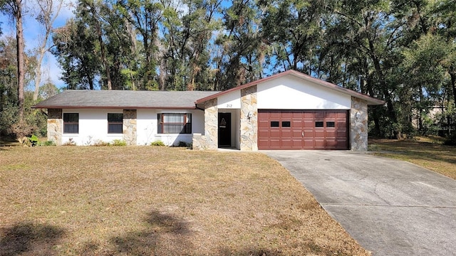 ranch-style home featuring a garage and a front lawn