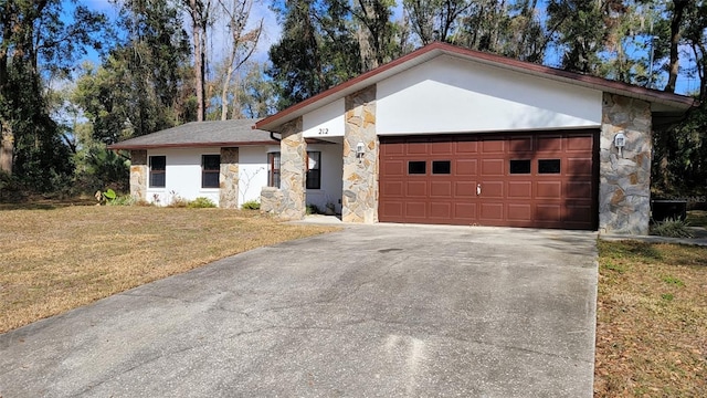 ranch-style house with a garage and a front yard