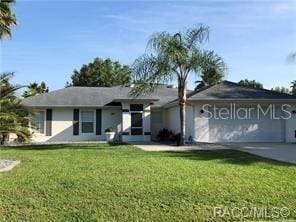 4457 E Avocet Ct, Inverness, FL 34453 - ranch-style house featuring a front yard, an attached garage, and driveway
