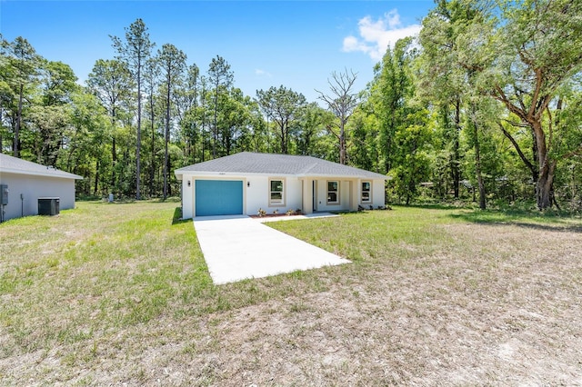 ranch-style house featuring an attached garage, central air condition unit, a front yard, and concrete driveway