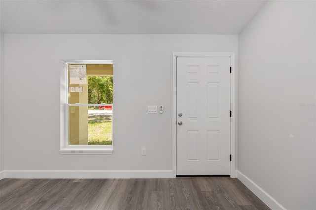 foyer entrance featuring baseboards and wood finished floors