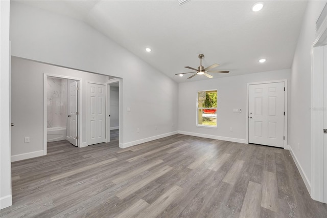 unfurnished living room with ceiling fan, wood finished floors, baseboards, lofted ceiling, and recessed lighting