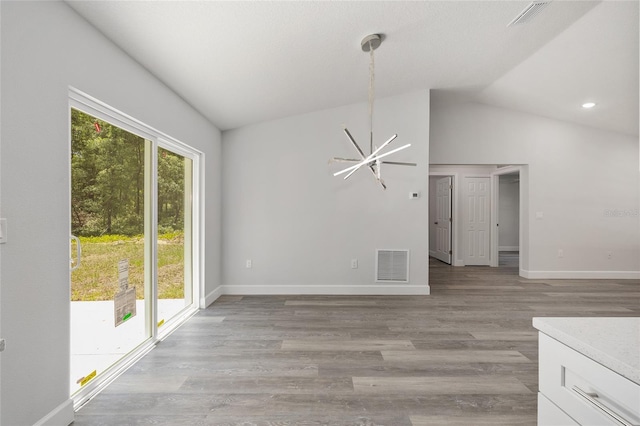 unfurnished dining area with visible vents, baseboards, lofted ceiling, and a chandelier