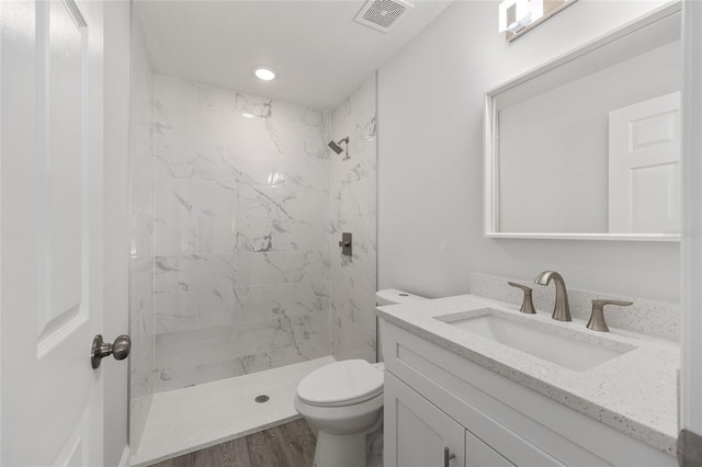 full bath with toilet, visible vents, a shower stall, and vanity
