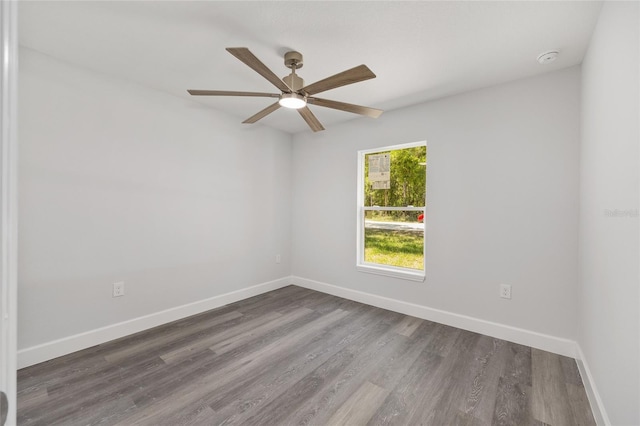 unfurnished room with a ceiling fan, baseboards, and wood finished floors