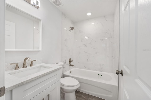 full bathroom with visible vents, shower / tub combination, wood finished floors, vanity, and toilet