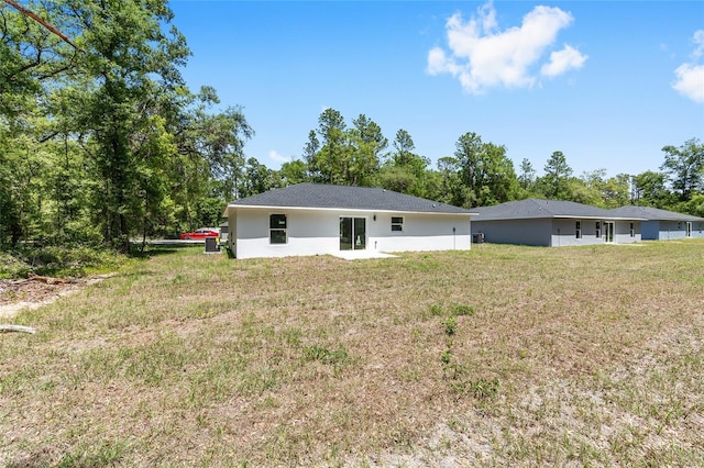 rear view of property featuring a yard