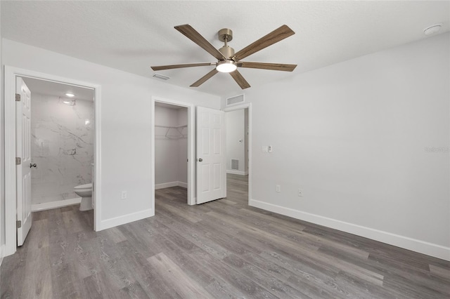 unfurnished bedroom featuring baseboards, visible vents, and wood finished floors