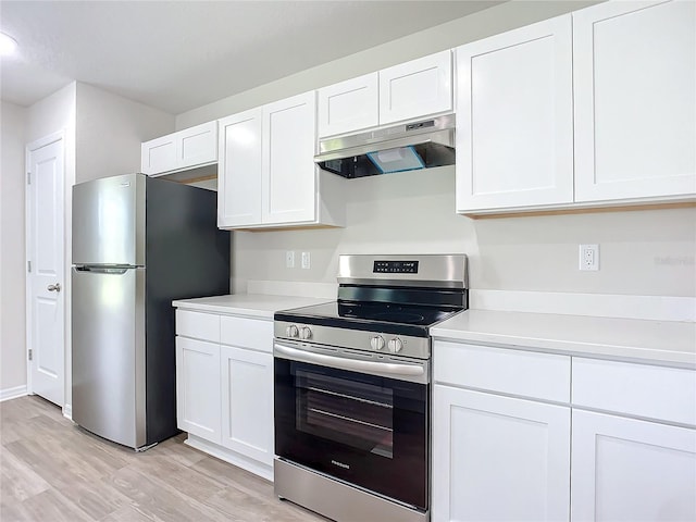 35 Wood Acre Ln, Palm Coast, FL 32164 - kitchen with stainless steel appliances, white cabinets, and light hardwood / wood-style flooring