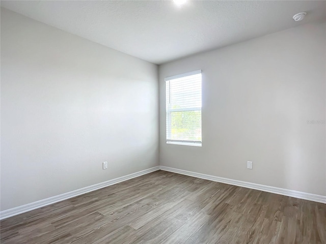 35 Wood Acre Ln, Palm Coast, FL 32164 - unfurnished room with wood-type flooring and a textured ceiling