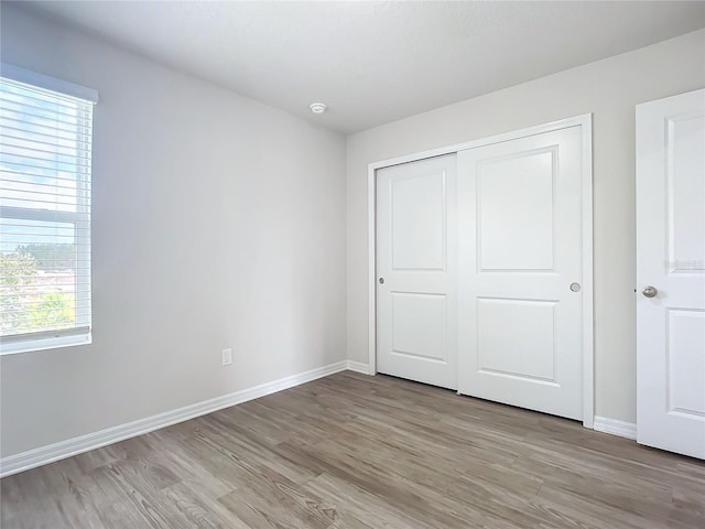 35 Wood Acre Ln, Palm Coast, FL 32164 - unfurnished bedroom featuring light hardwood / wood-style flooring and a closet